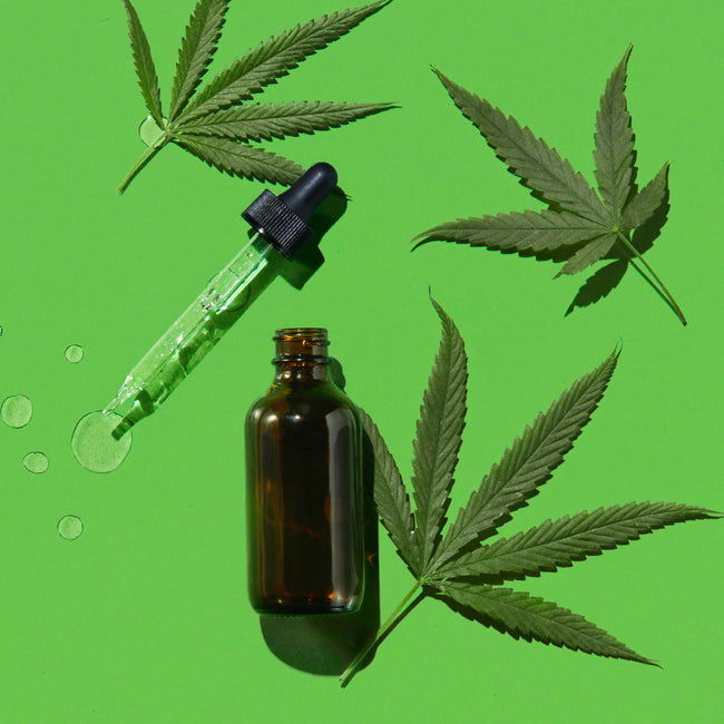 Bottle with dropper and hemp leaves